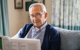 Bien dans mon environnement, un retraité lisant son journal sur son canapé